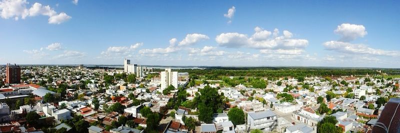 View of cityscape against cloudy sky