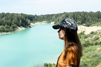 Side view of young woman looking at waterfall