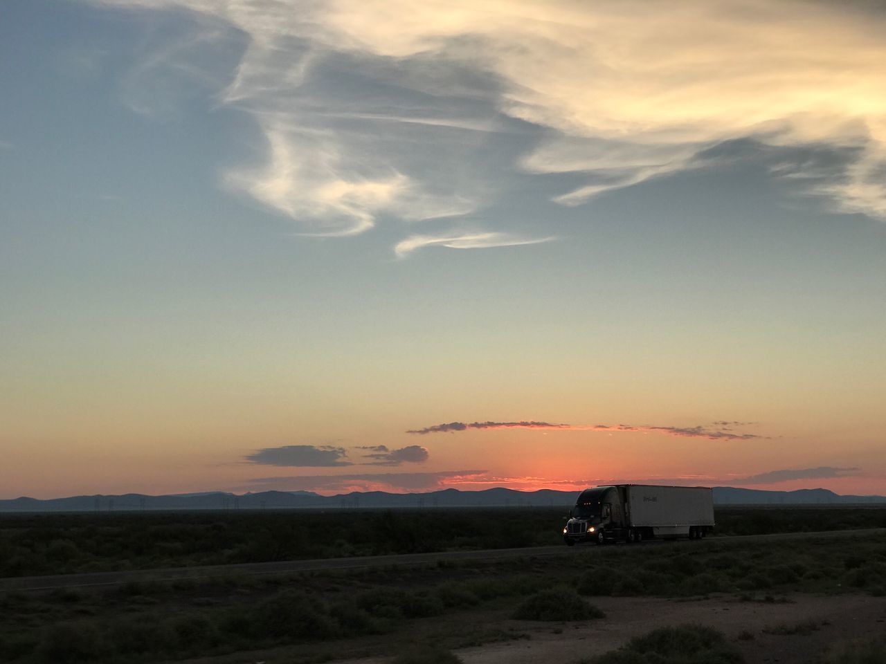 SCENIC VIEW OF SKY OVER LANDSCAPE AGAINST ORANGE SUNSET