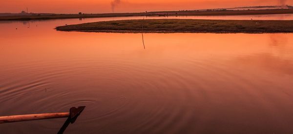 Scenic view of lake against sky during sunset