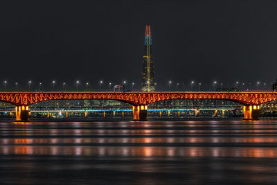 View of bridge over river at night