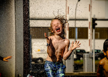 Shirtless boy playing with water