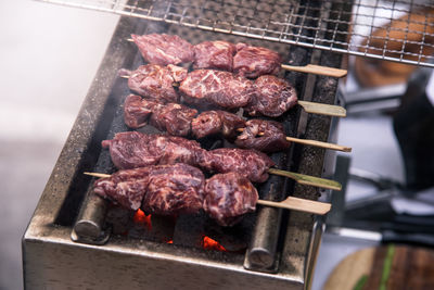 High angle view of meat on barbecue grill