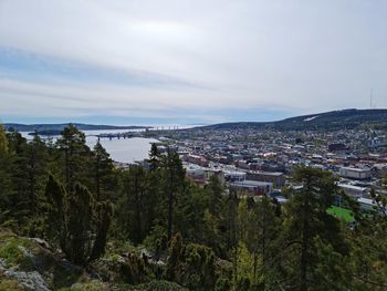 High angle view of townscape and trees against sky