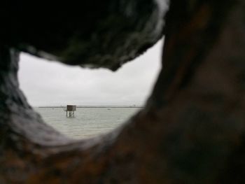 Scenic view of sea seen through hole