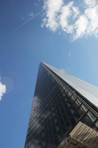 Low angle view of modern building against blue sky