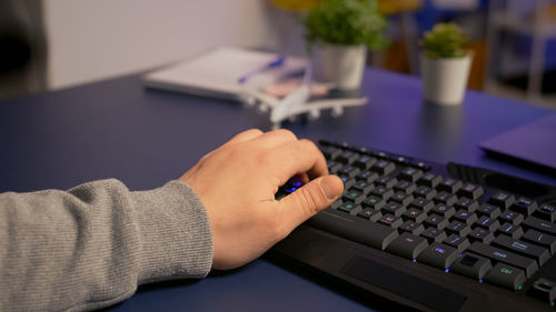 Midsection of person using laptop on table