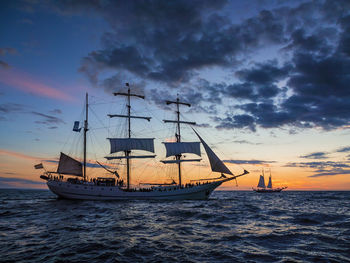 Ship sailing on sea against sky