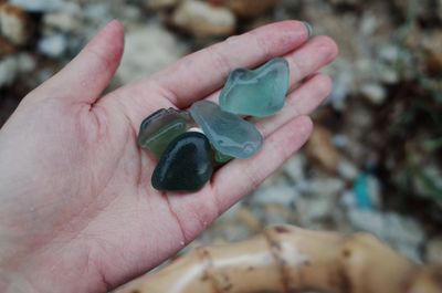 Cropped hand holding gemstones