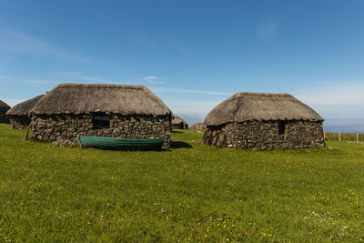 Houses on field against sky