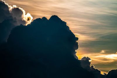 Low angle view of silhouette mountain against dramatic sky