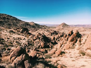 View of rocky mountain against blue sky