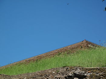 Low angle view of built structure against clear blue sky