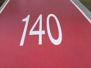 High angle view of arrow sign on road