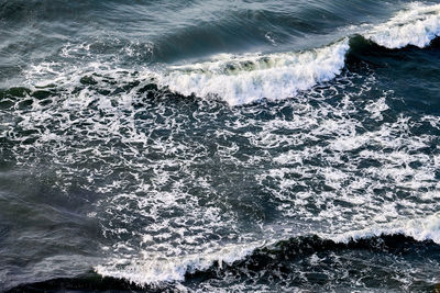 Deep blue sea waters splashing with foamy waves. aerial view of ocean splashing waves, dark blue sea