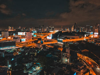 High angle view of illuminated buildings in city at night