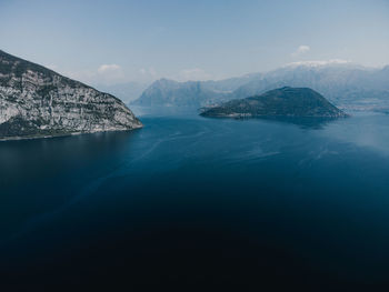 Scenic view of sea and mountains against sky