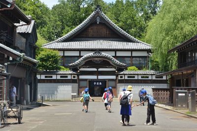 People in front of built structure