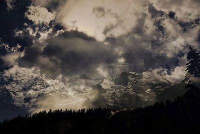 Scenic view of mountains against cloudy sky