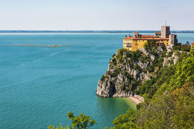 Gulf of trieste. high cliffs between boats, karst rocks and ancient castles. duino. italy