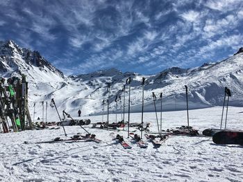 Ski lift on snowcapped mountains against sky