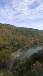 Scenic view of river and landscape against sky