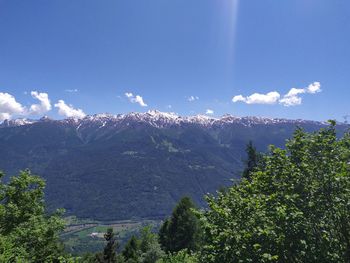 Scenic view of mountains against blue sky