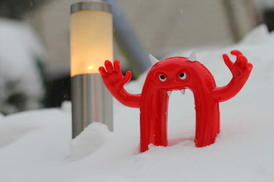 Close-up of red toy on snow