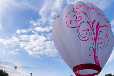 Low angle view of hot air balloon flying against sky