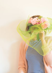 Midsection of woman holding flower bouquet