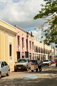 Cars on street against buildings in city