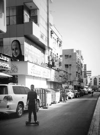 People on street in city against clear sky