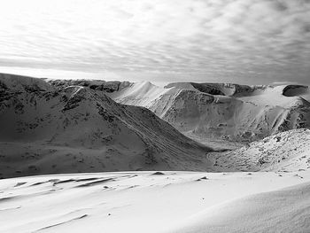 Scenic view of desert against sky during winter