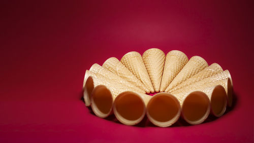 A group of empty waffles cones on red background