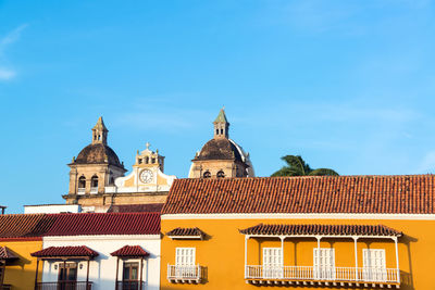 Low angle view of buildings against blue sky