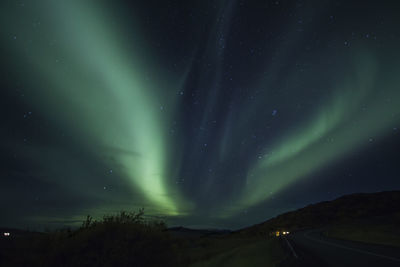 Scenic view of mountain against sky at night