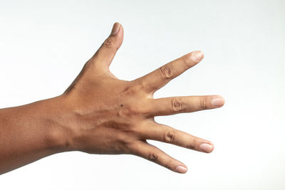 Close-up of human hand against white background