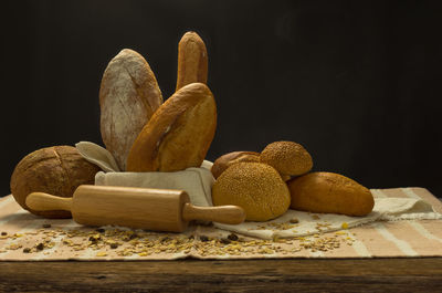 Close-up of bread on table against black background