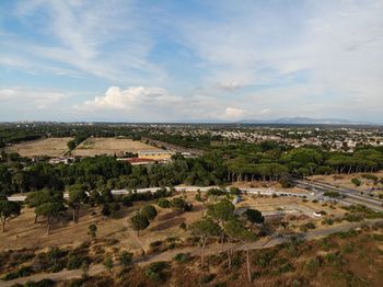 Aerial view of trees and buildings against sky