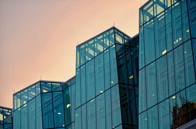 Low angle view of modern building against sky at dusk