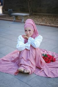 Portrait of young woman sitting on floor