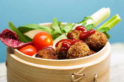 Close-up of fruits in container on table