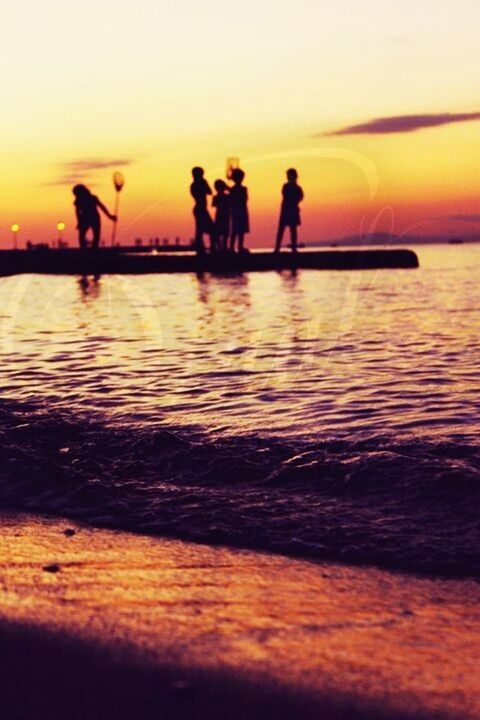 sunset, silhouette, water, lifestyles, men, sea, leisure activity, orange color, togetherness, person, reflection, sky, standing, scenics, medium group of people, vacations, beauty in nature, tranquility