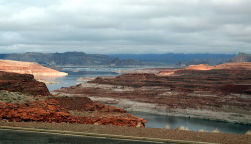 Scenic view of sea and mountains against sky