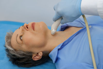 High angle view of young woman lying on bed