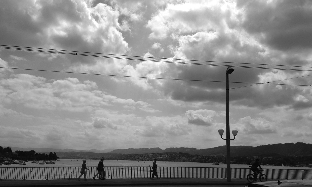 sky, cloud - sky, cloudy, men, lifestyles, railing, leisure activity, cloud, street light, water, person, nature, walking, weather, overcast, day, tranquility, sea