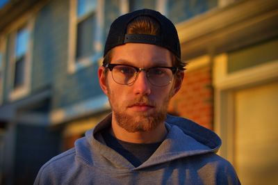 Portrait of young man wearing eyeglasses and cap