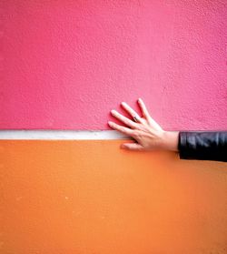 Close-up of hand against wall