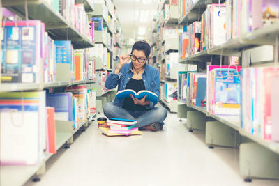 Young woman sitting on book