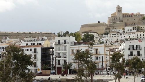 Buildings in city against sky